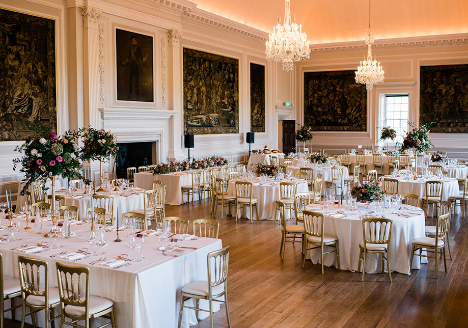 Wedding meal set up with long top table and circular tables for guests